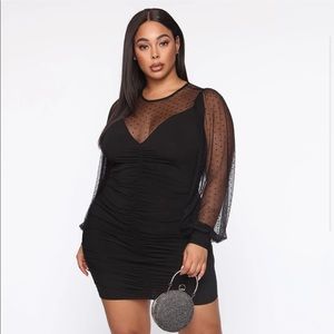 In a ruched bodycon mini dress
